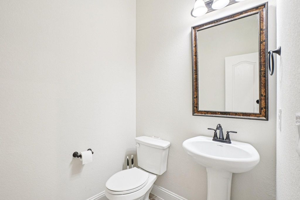 Bathroom with toilet and a textured wall