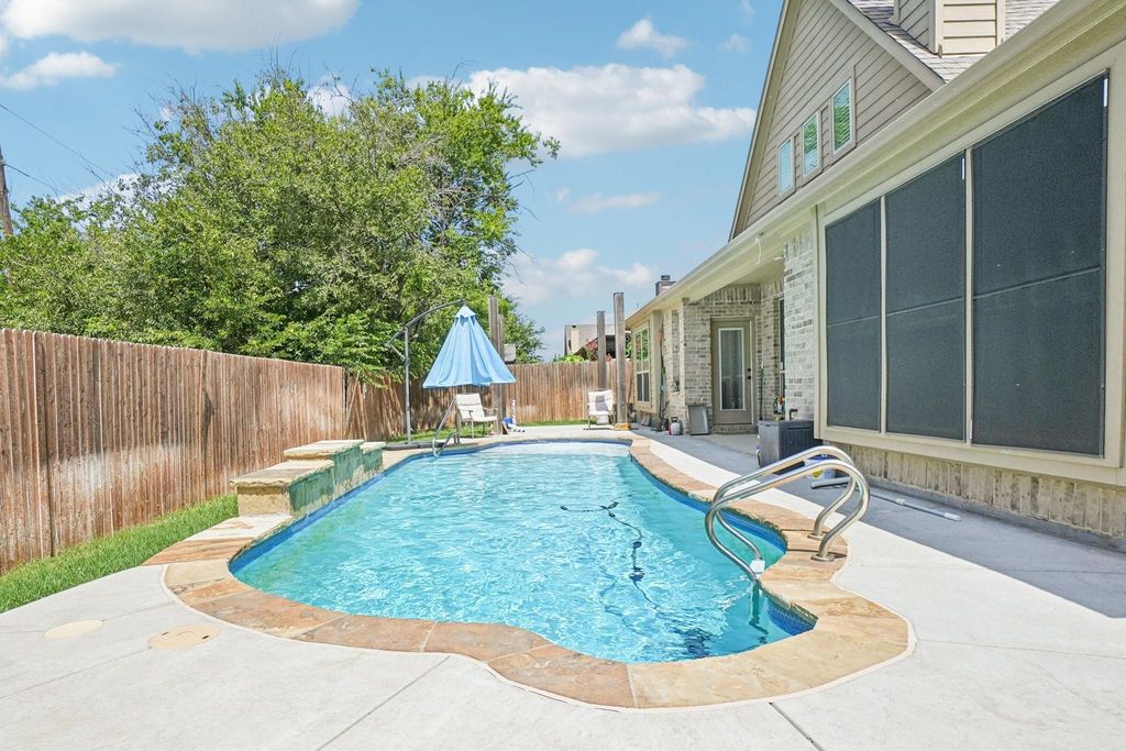 View of pool with a fenced backyard and a patio area