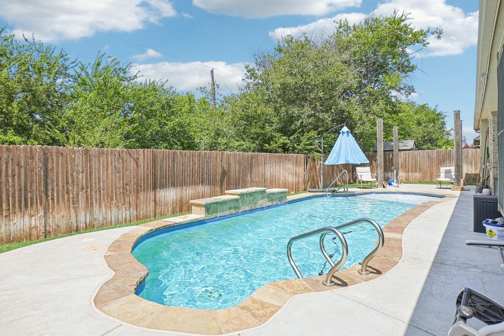 View of swimming pool featuring a patio area and a fenced backyard