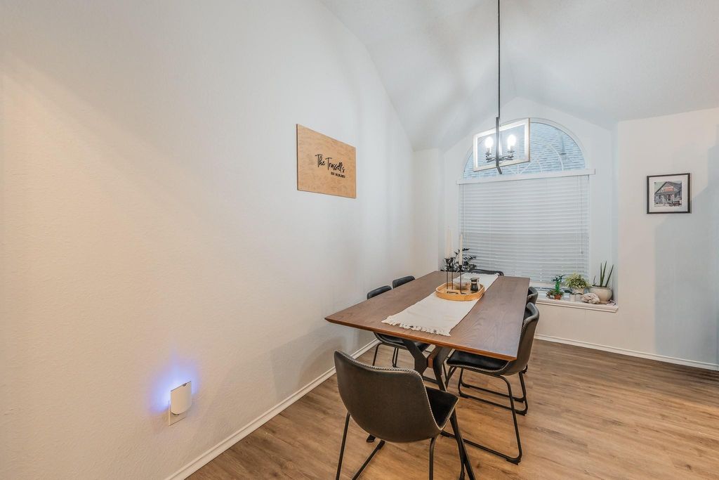 Dining space featuring lofted ceiling, light wood-type flooring, and a chandelier