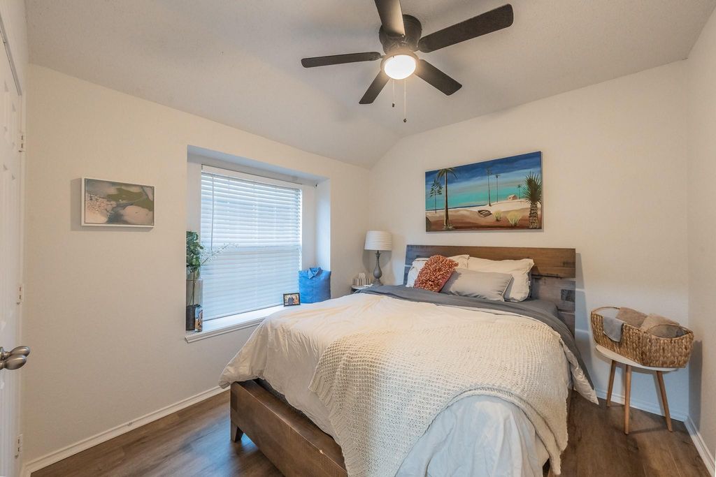 Bedroom featuring wood finished floors, ceiling fan, and lofted ceiling