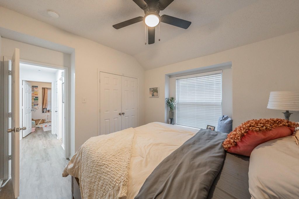 Bedroom featuring wood finished floors, ceiling fan, vaulted ceiling, and a closet