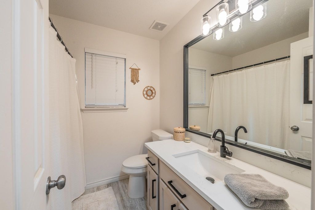 Bathroom featuring vanity and light wood-style floors