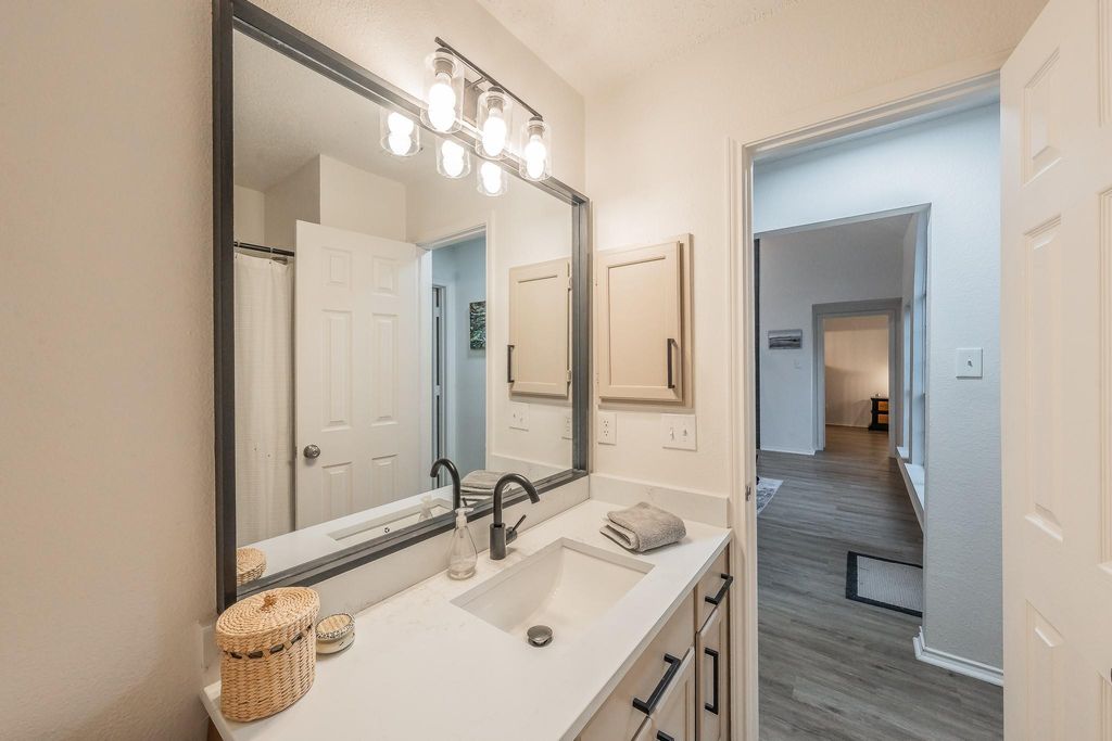 Bathroom featuring vanity and dark wood-style floors