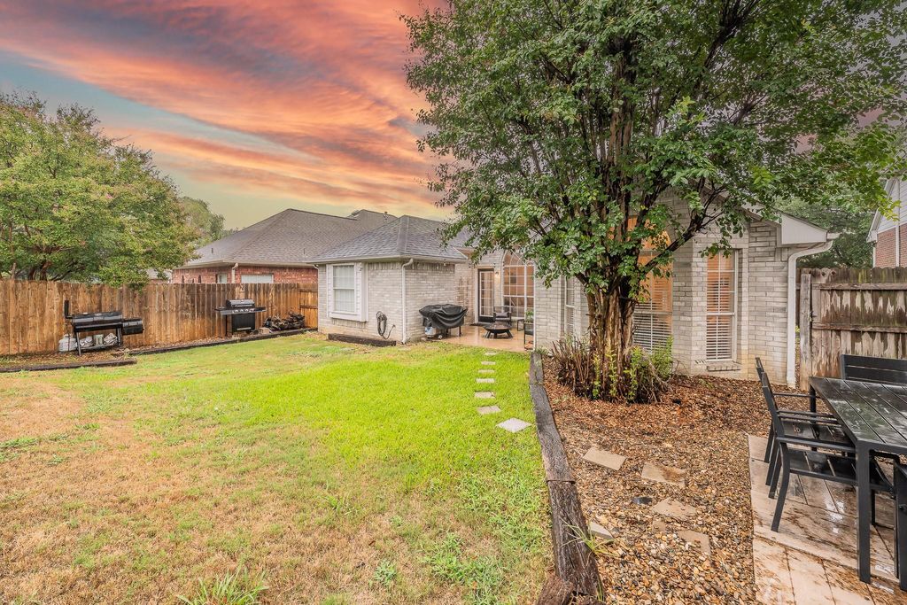 Yard at dusk featuring a patio area and a fenced backyard