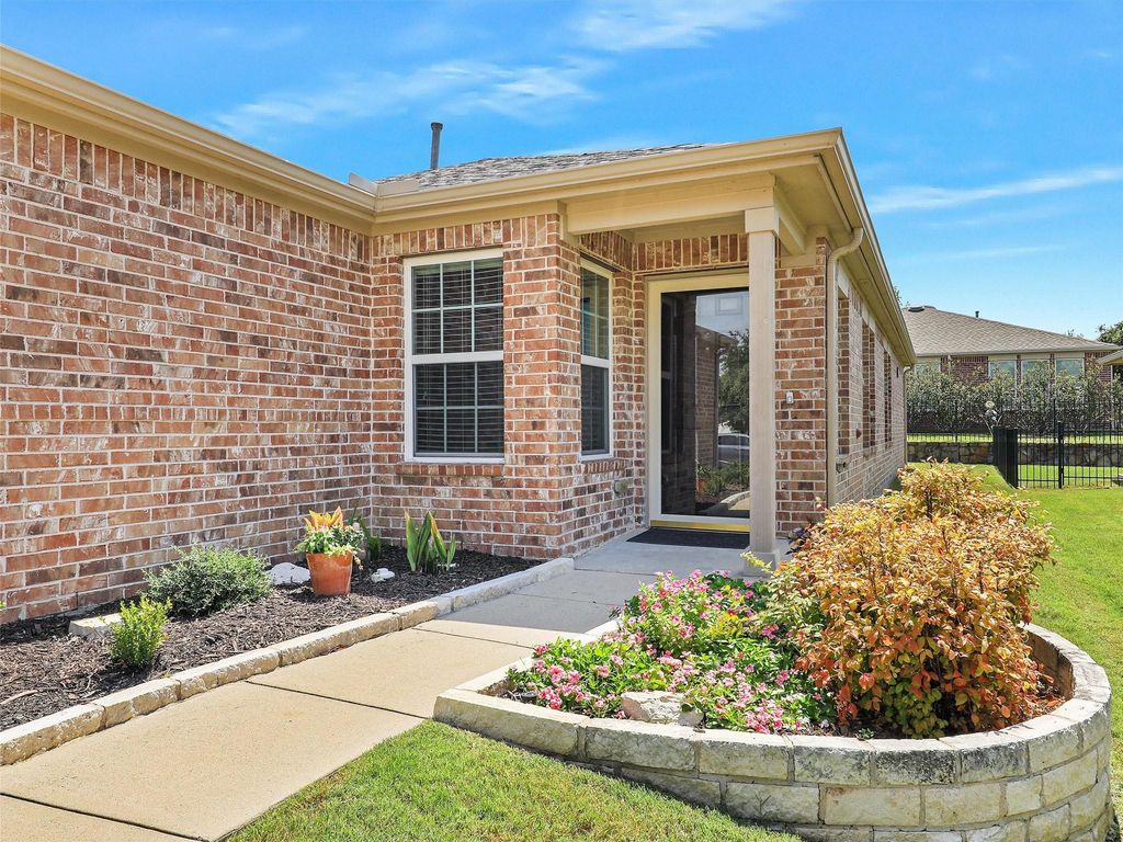 View of exterior entry featuring brick siding