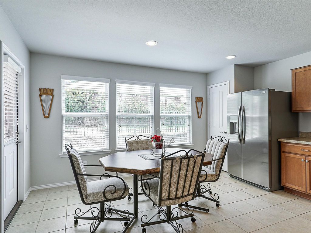 Dining area featuring light tile patterned floors and recessed lighting