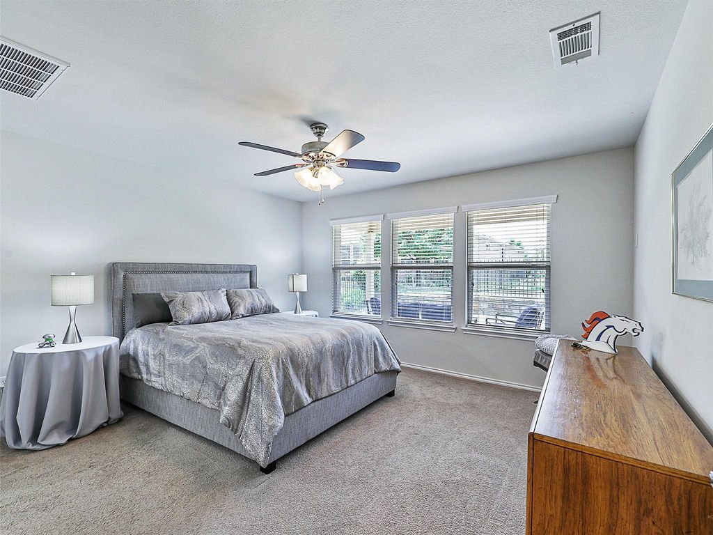 Bedroom featuring light colored carpet and ceiling fan