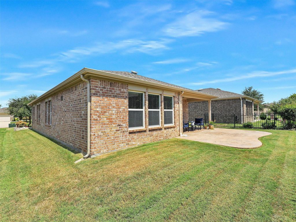 Rear view of house with a patio and brick siding