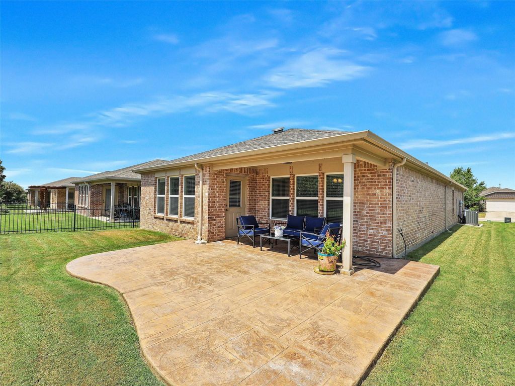 Rear view of property with a patio area, brick siding, outdoor lounge area, and a shingled roof