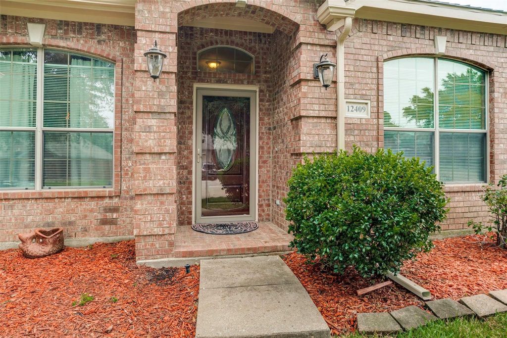 Doorway to property with brick siding