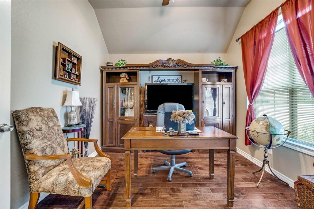 Office space with lofted ceiling and wood finished floors