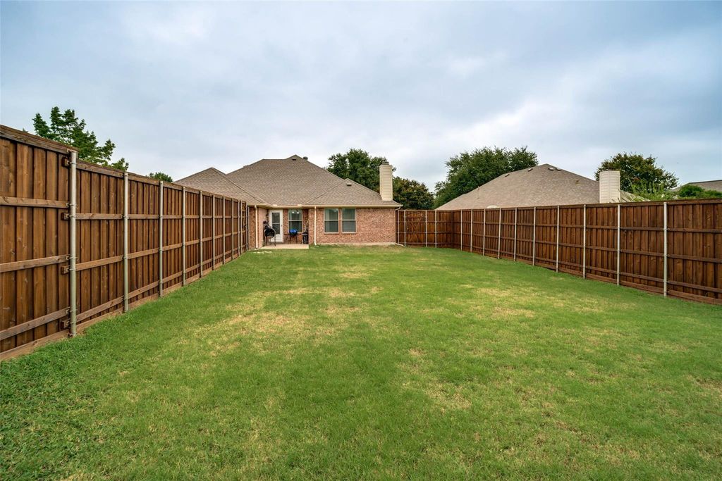 Fenced backyard with a patio