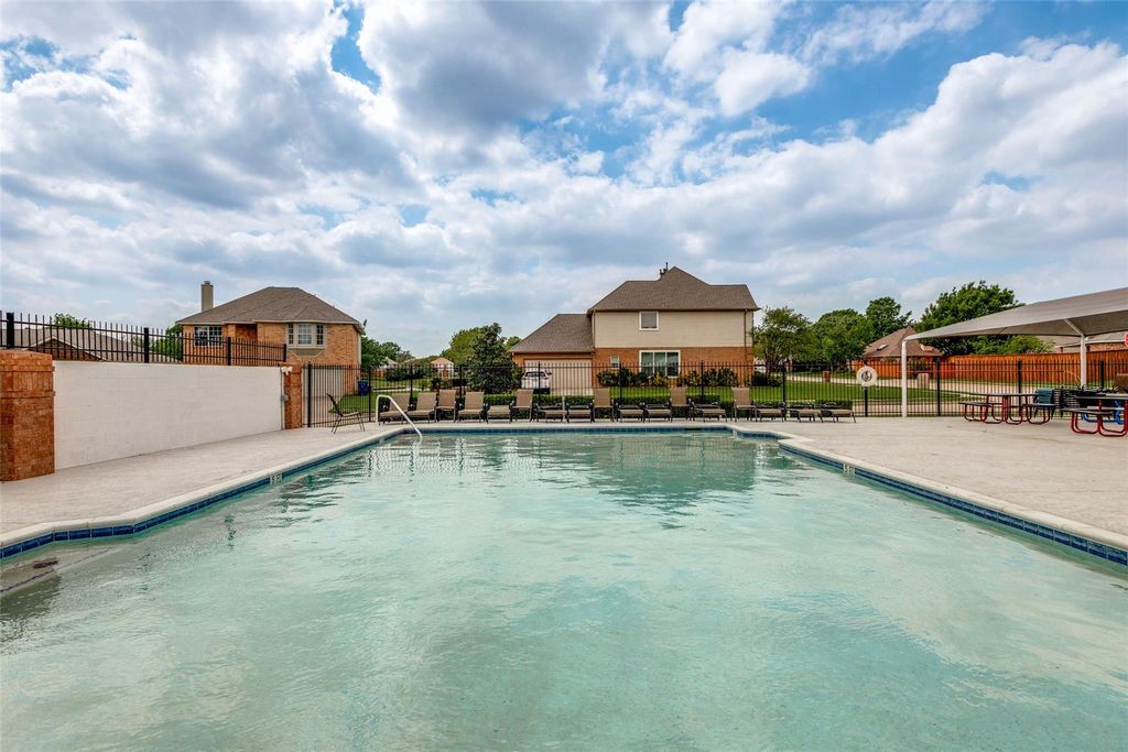 Community pool with a patio