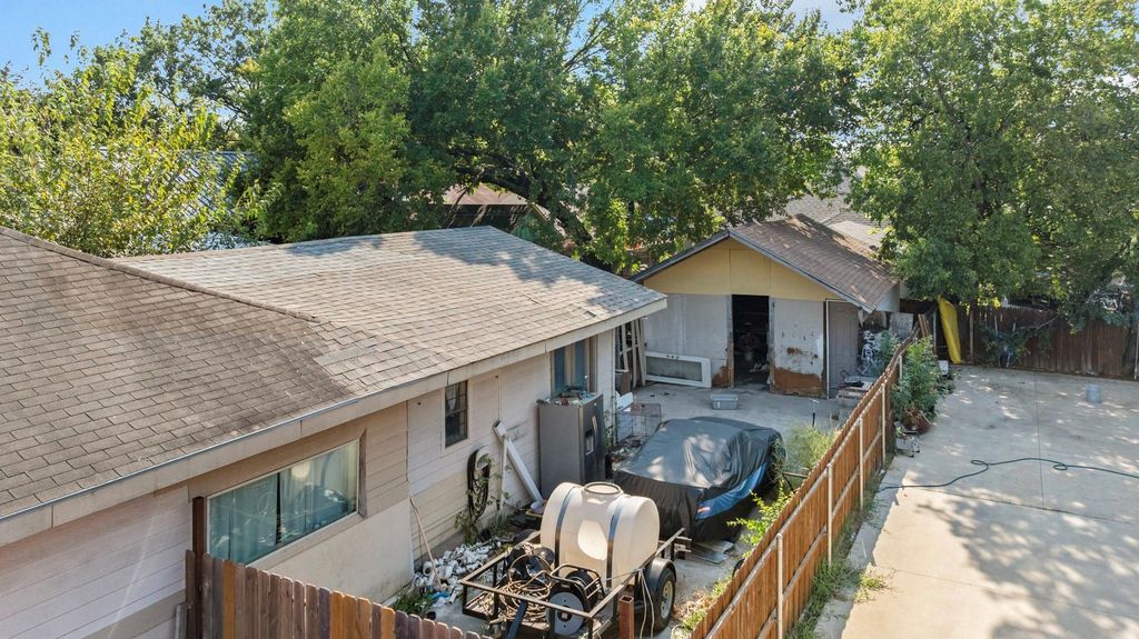 Back of house with roof with shingles and a patio area
