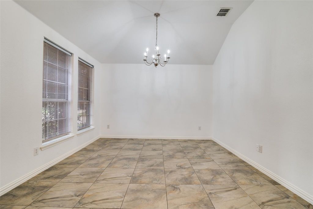 Dining area with a chandelier and lofted ceiling