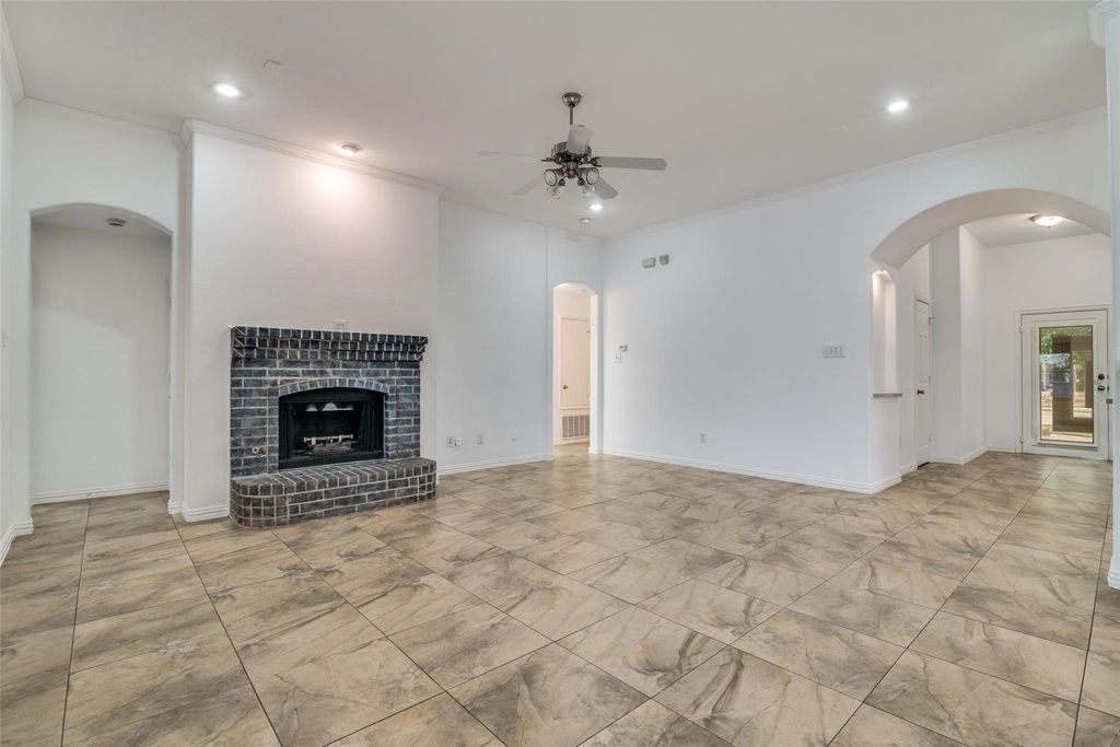  living room featuring arched walkways,  a brick fireplace, ceiling fan, and recessed lighting