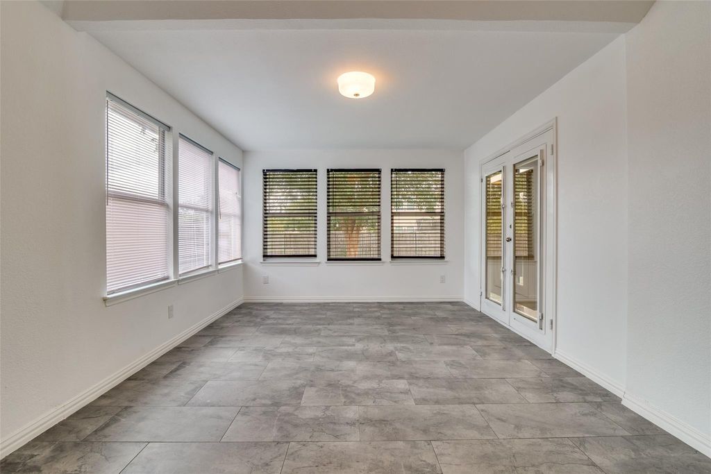 Sunroom featuring french doors and baseboards