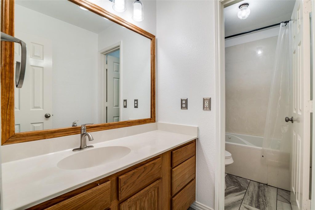 Bathroom with shower / bath combo and vanity