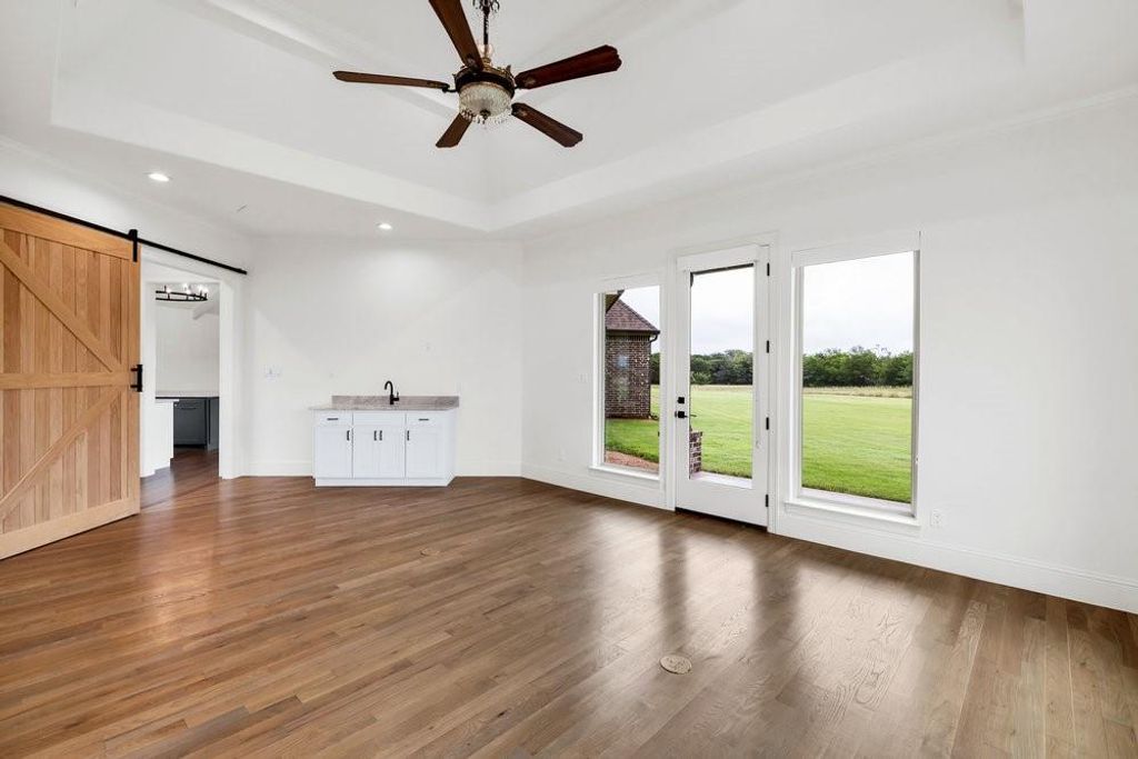 Game or Movie Room w/ Sink & Outdoor Entrance to Covered Patio
