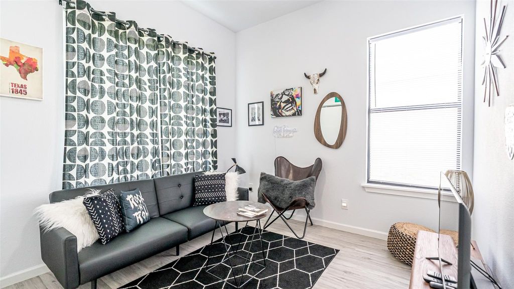 Living area featuring light wood-style floors and baseboards