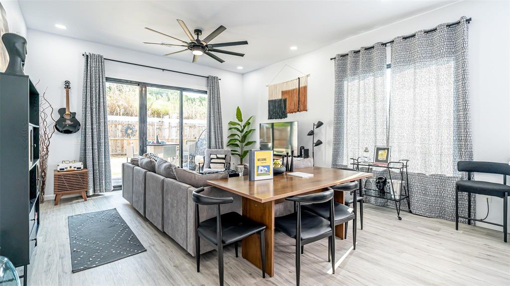 Dining room with light wood-type flooring, a ceiling fan, and recessed lighting