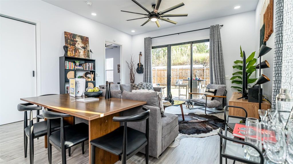 Living room with light wood finished floors, a ceiling fan, and recessed lighting