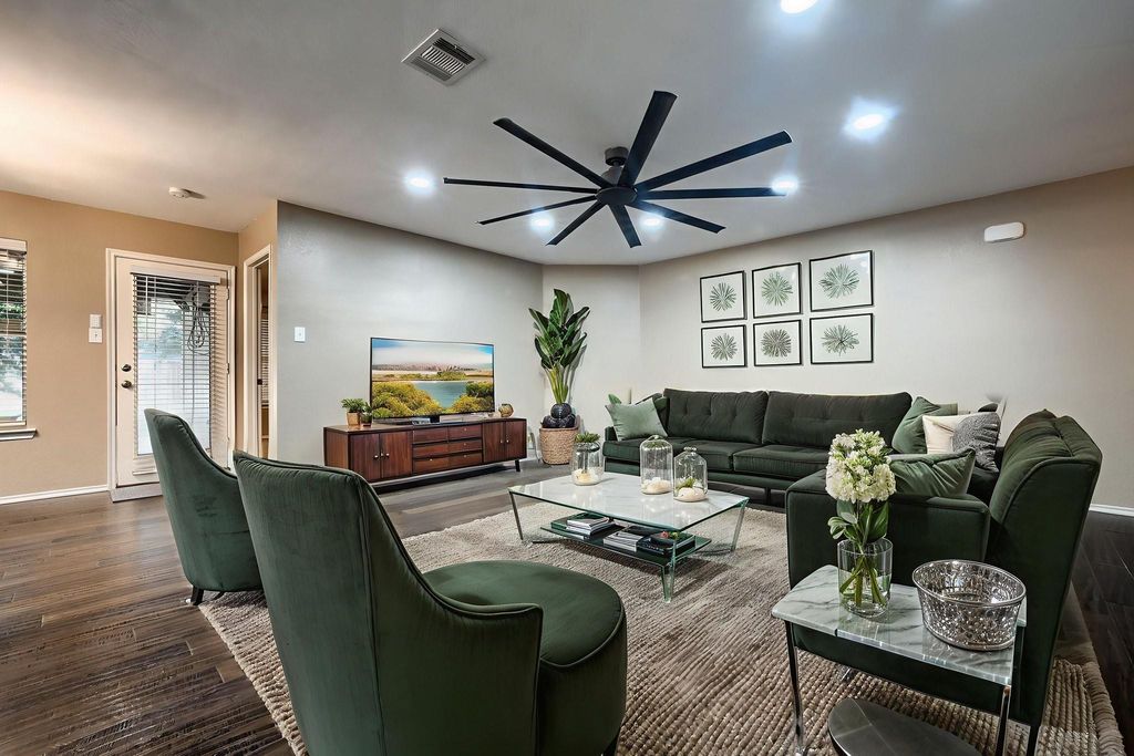Living area with wood finished floors, ceiling fan, and recessed lighting