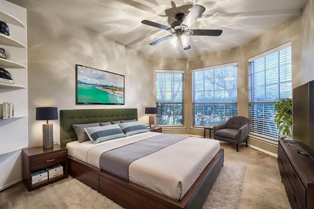 Bedroom featuring light carpet and a ceiling fan