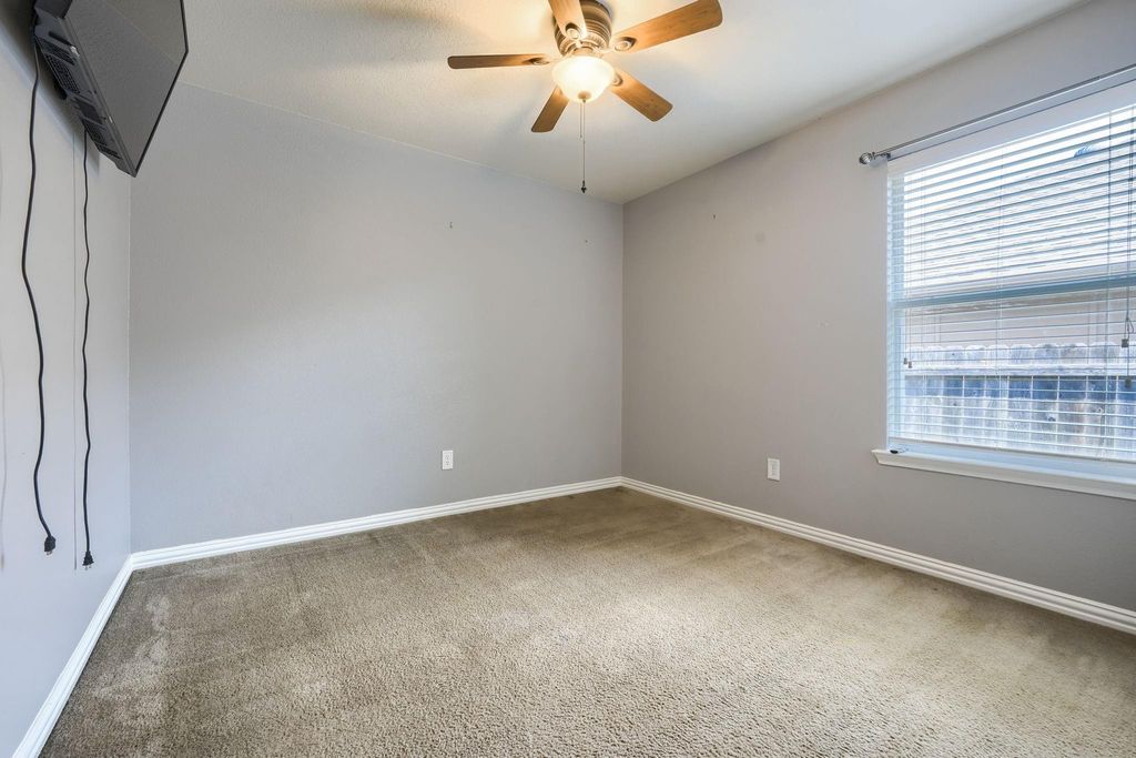 Bedroom with light colored carpet and ceiling fan