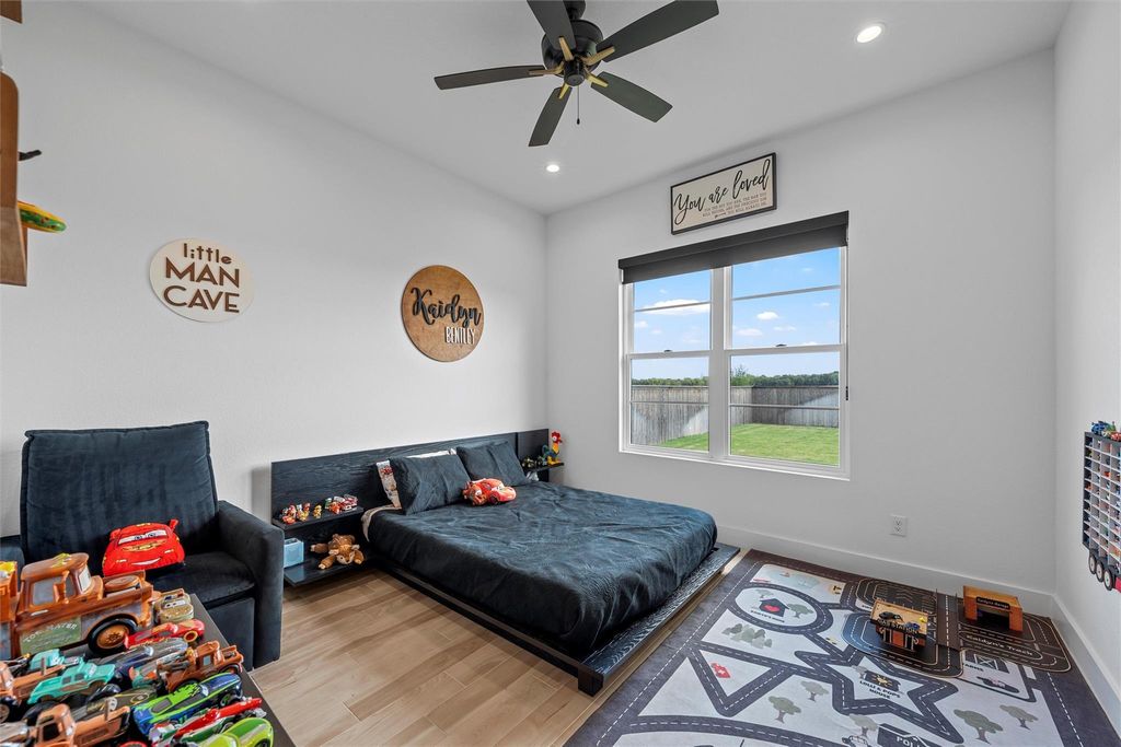 Bedroom with wood finished floors, recessed lighting, and a ceiling fan