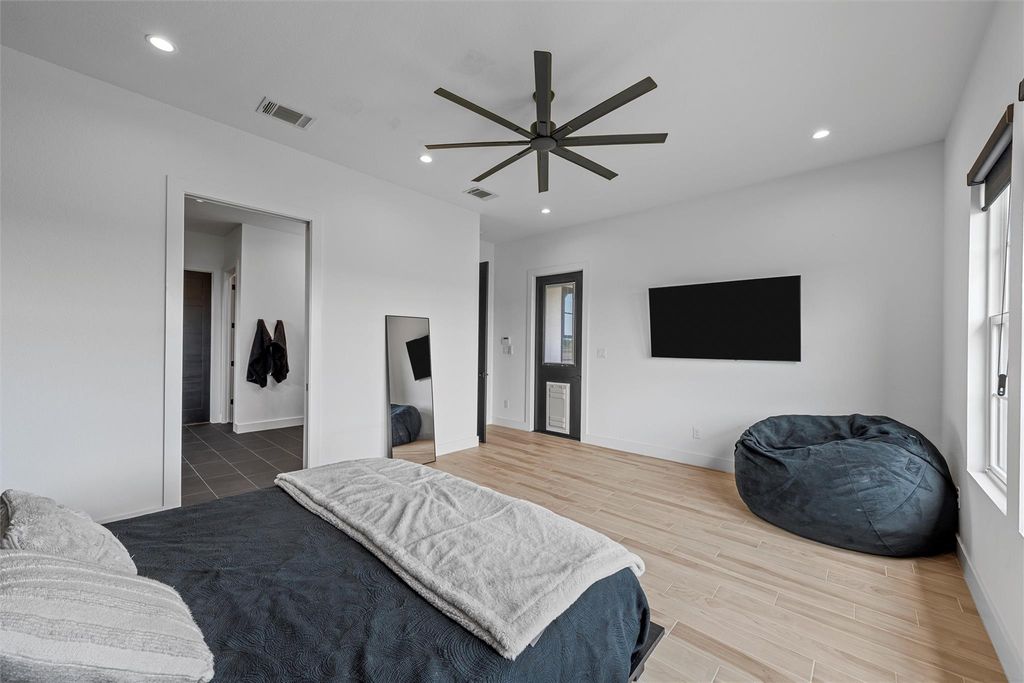 Bedroom with recessed lighting, light wood-style floors, and a ceiling fan