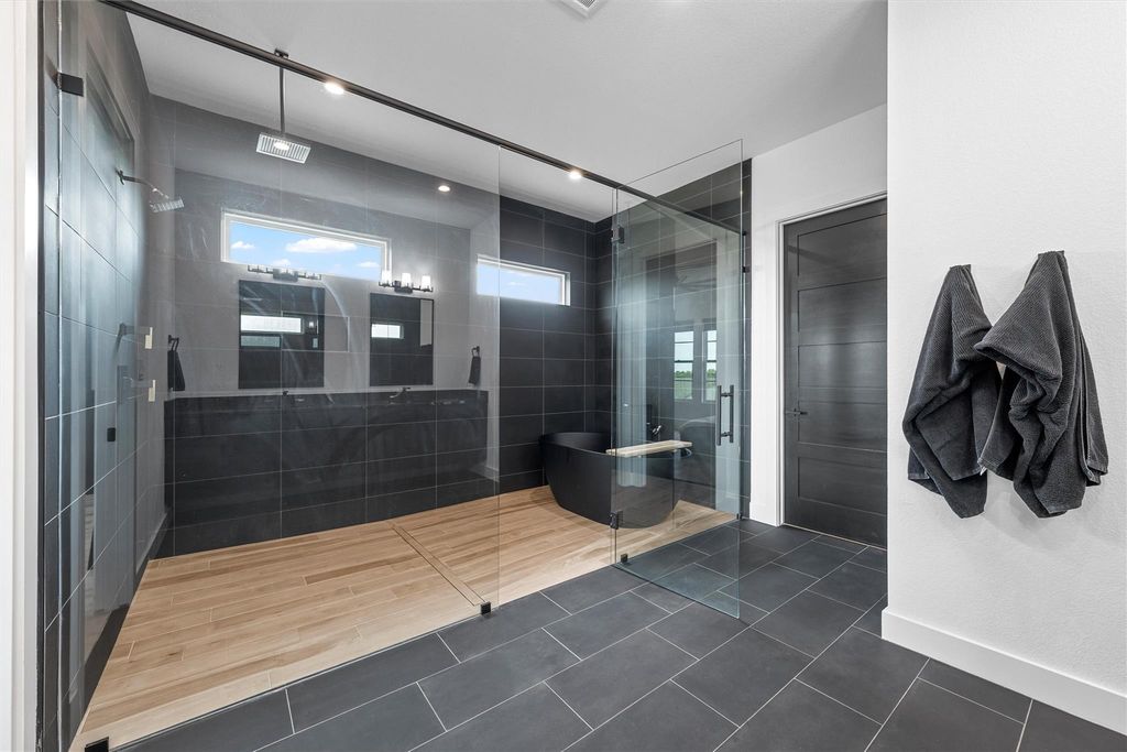 Full bathroom with a stall shower, a soaking tub, and tile patterned flooring