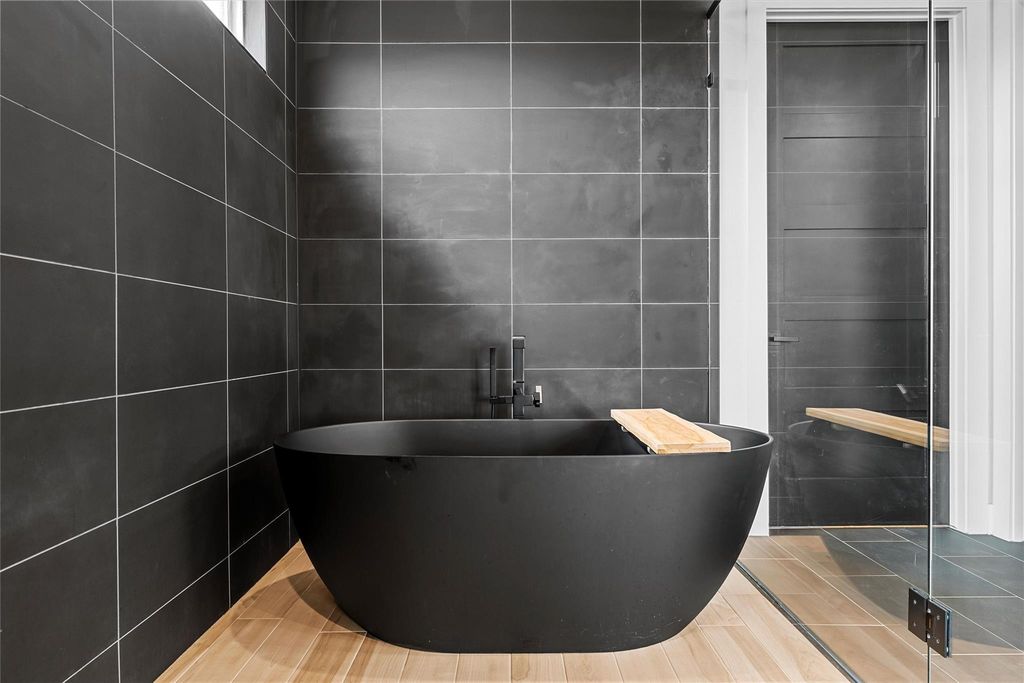 Full bathroom with a freestanding bath, tile walls, and tile patterned floors