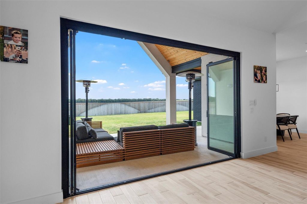 Doorway featuring baseboards and wood finished floors