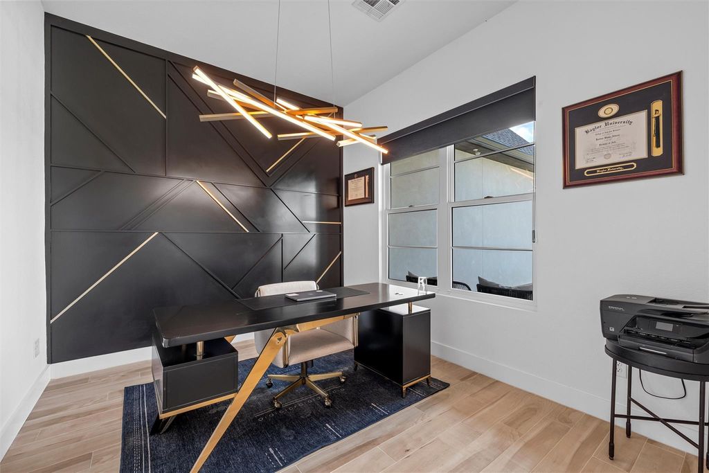 Office space featuring an accent wall and light wood-style flooring