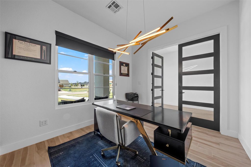 Office space with baseboards and light wood-style flooring