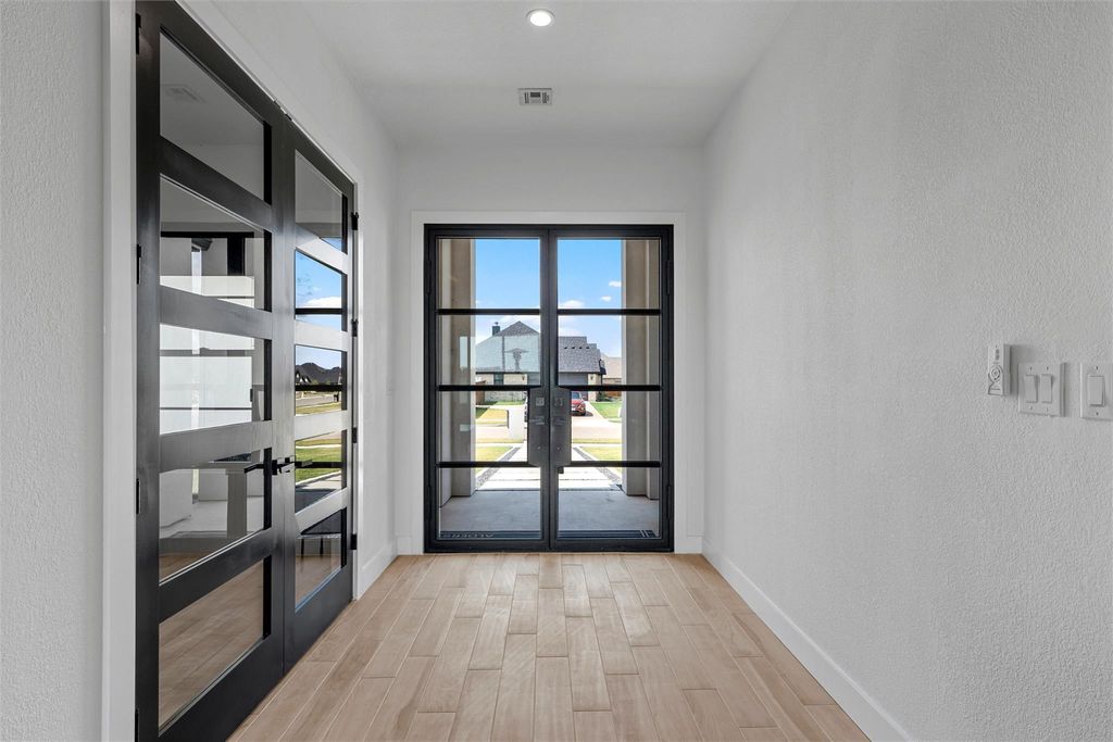 Doorway to outside featuring a textured wall, french doors, wood finished floors, and recessed lighting