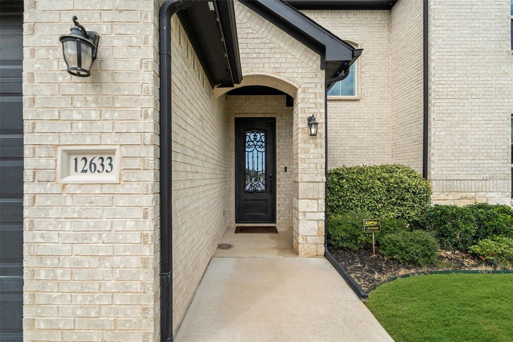 View of exterior entry with brick siding