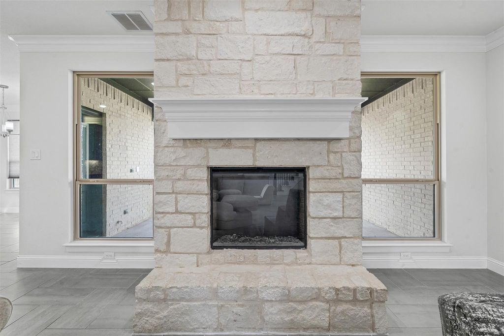 Detailed view of crown molding and a fireplace