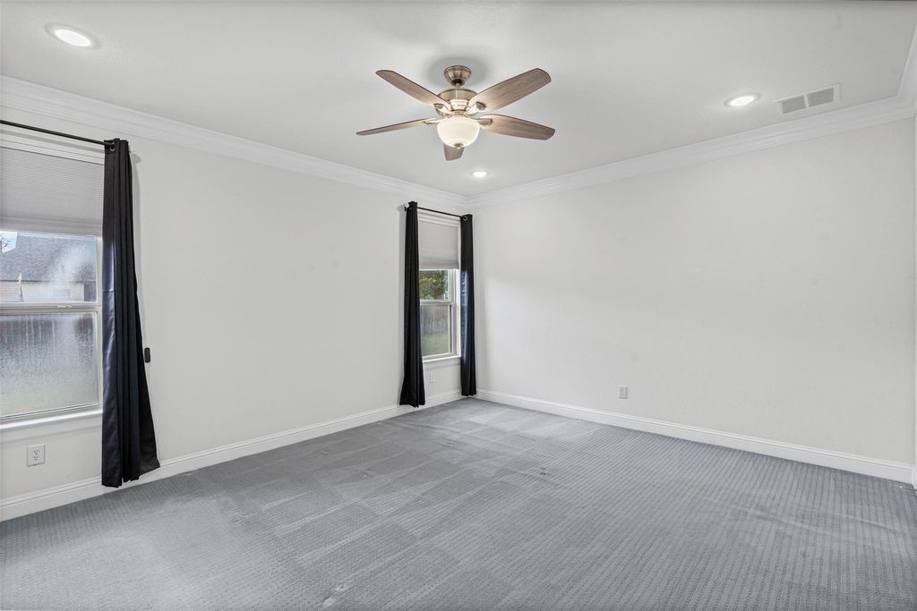Carpeted spare room featuring ornamental molding, recessed lighting, and ceiling fan