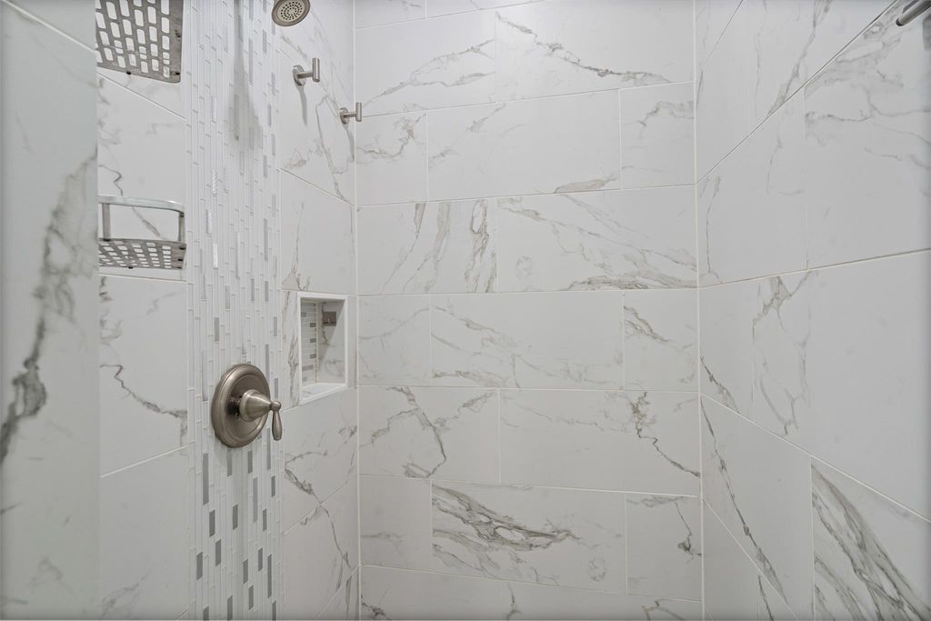 Full bath with a tile shower