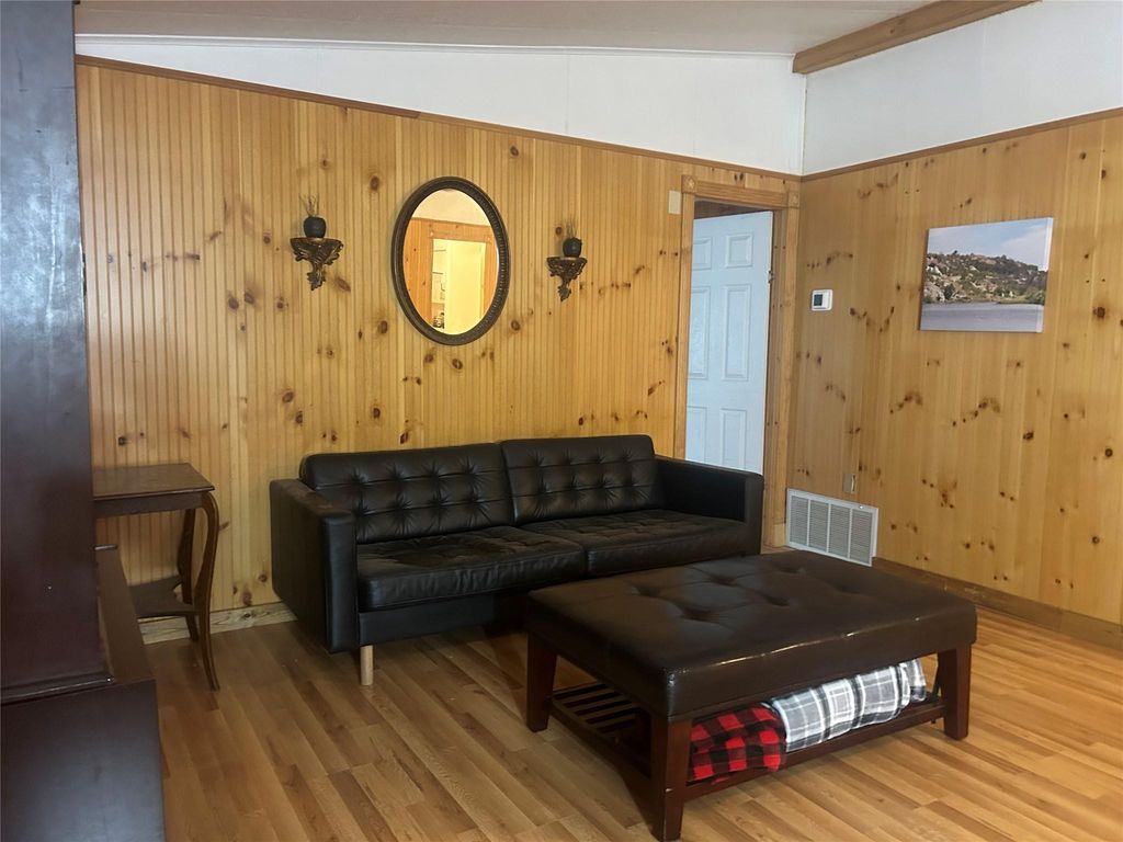 Living room featuring wood walls and wood finished floors