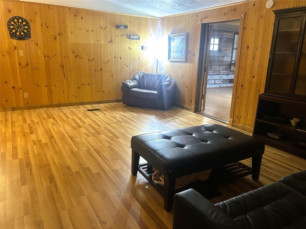 Living area featuring wooden walls and wood finished floors