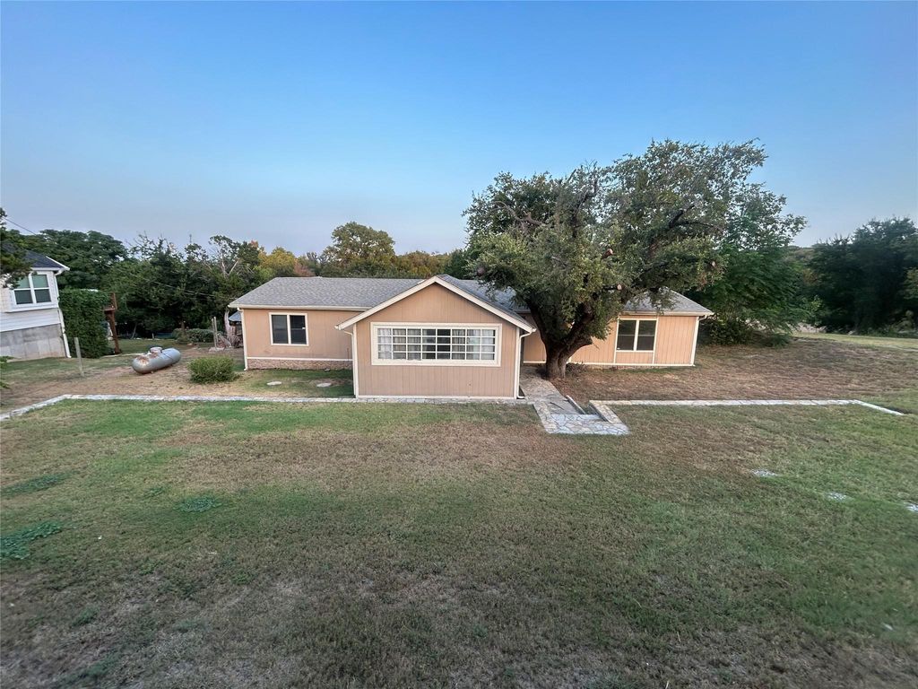 Ranch-style house with a front lawn