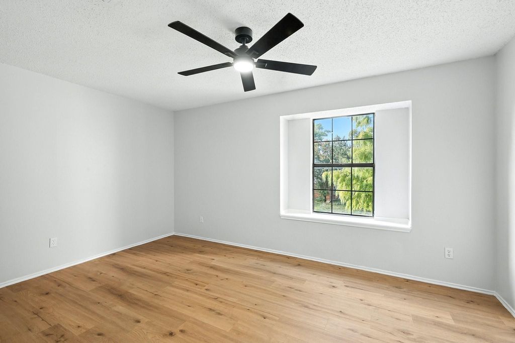 Unfurnished bedroom featuring a textured ceiling and light wood finished floors