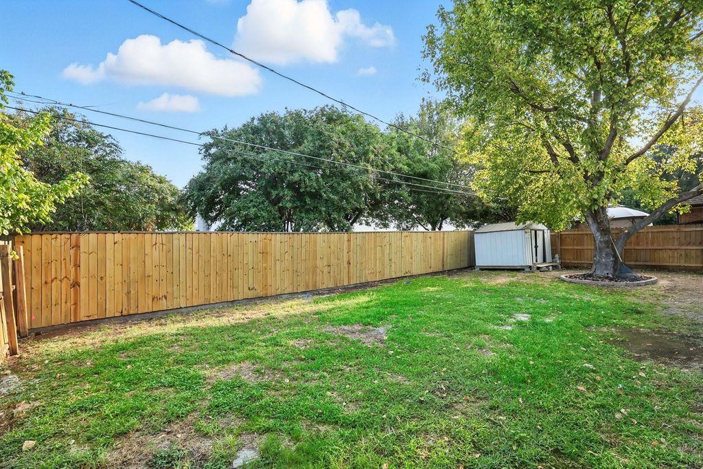 Fenced backyard with a storage unit