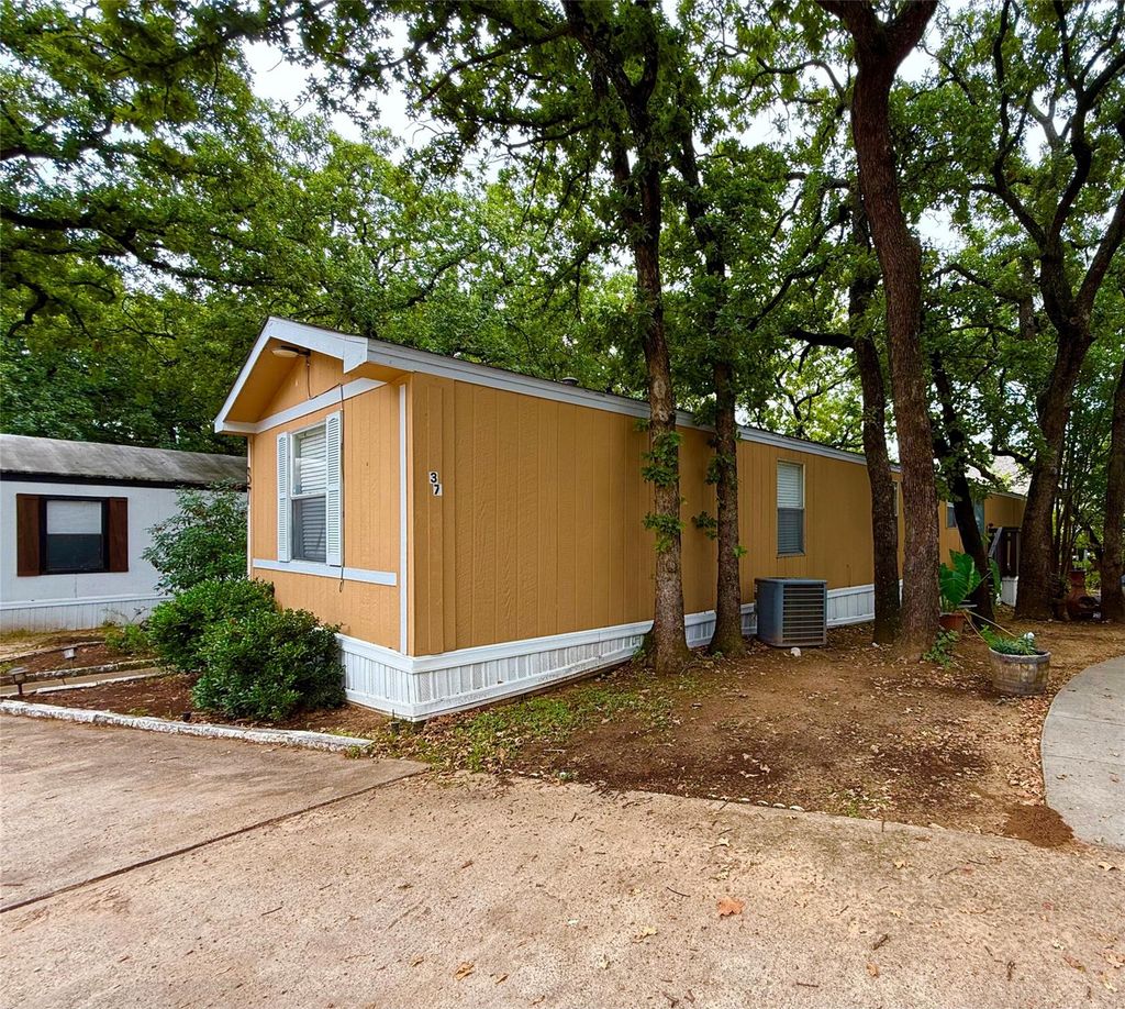 View of side of home featuring a central air condition unit
