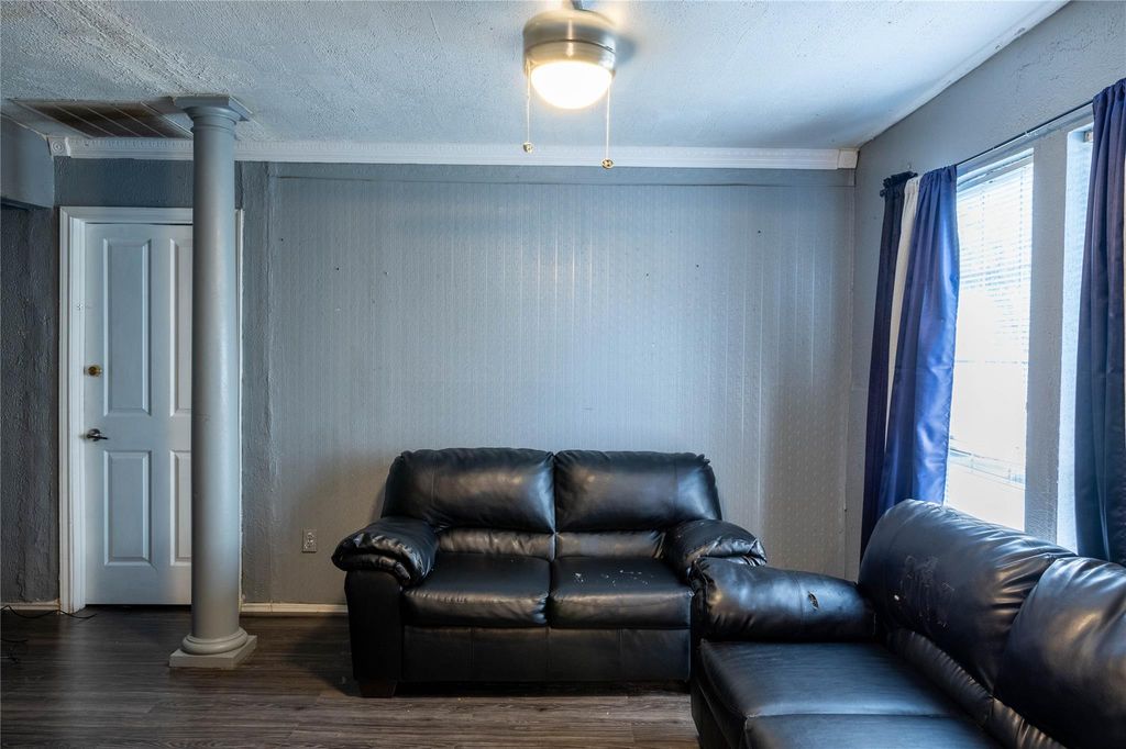 Living room with wood finished floors and a textured ceiling