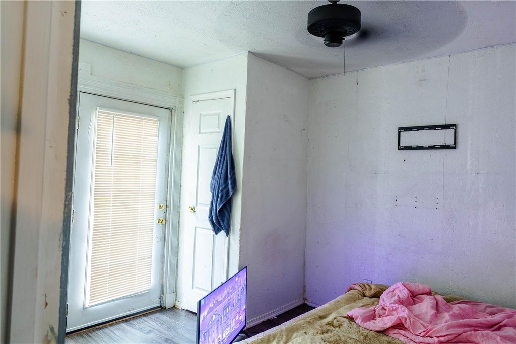 Bedroom featuring wood finished floors and ceiling fan